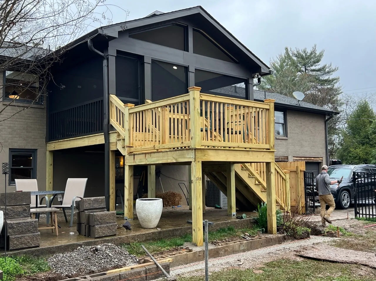 Elevated screened porch with a new pressure-treated deck and stairs under construction